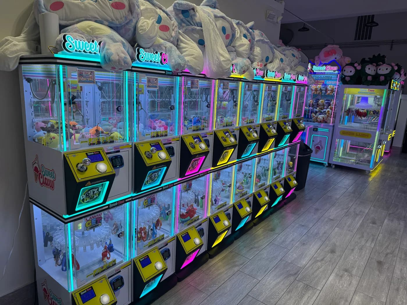 Stacked capsule toy machines in blue, yellow and pink