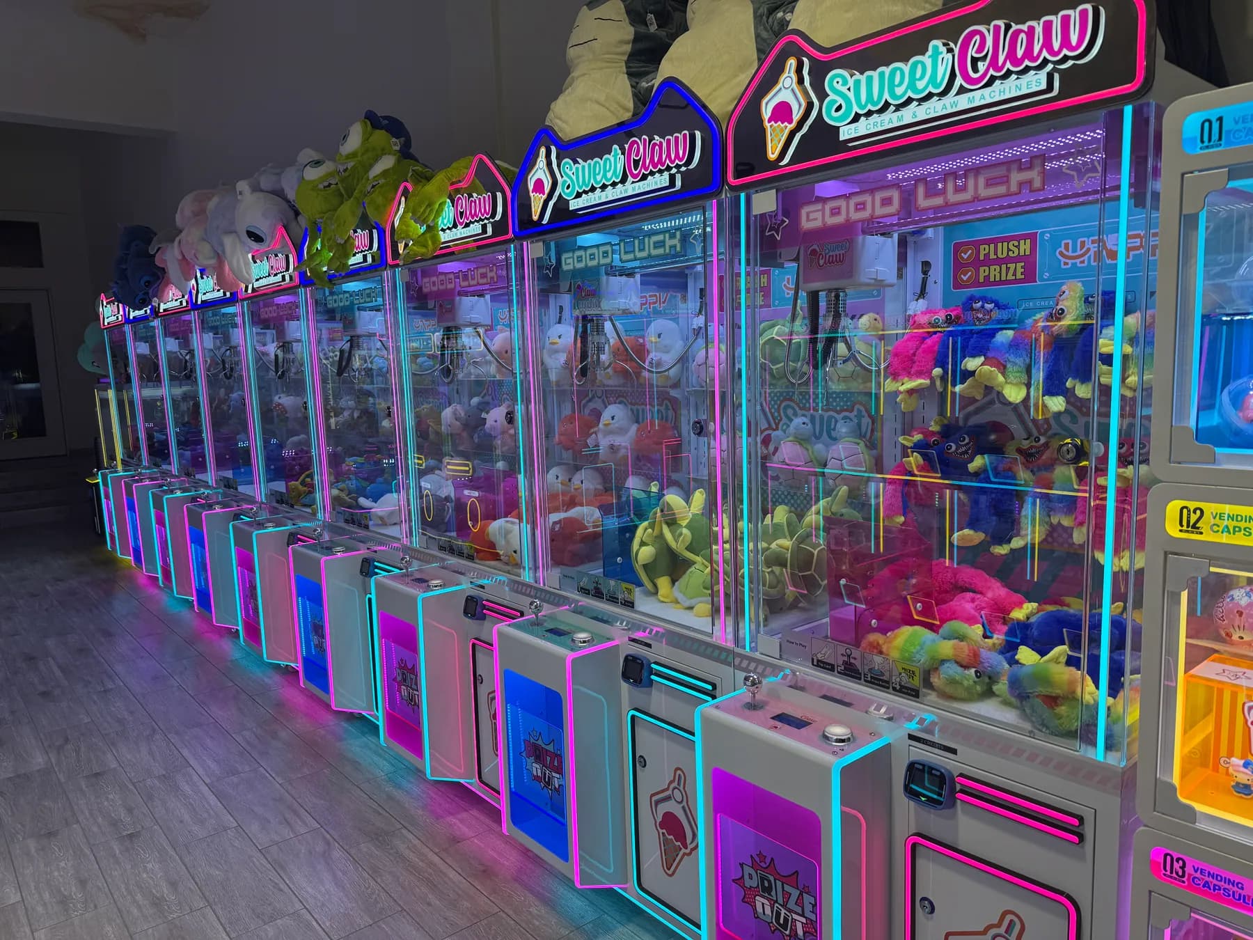 A row of claw machines packed with plush toys